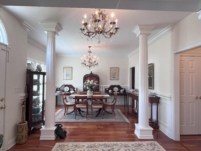 dining room featuring a notable chandelier, dark wood-type flooring, ornate columns, and ornamental molding