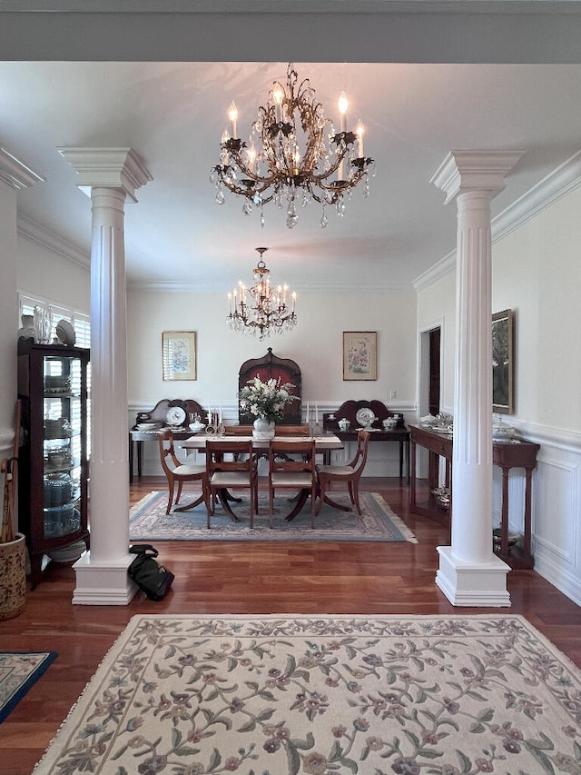 dining area featuring dark hardwood / wood-style floors, decorative columns, and a chandelier