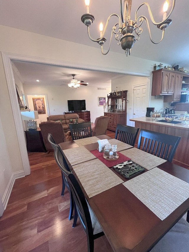 dining space with dark hardwood / wood-style floors and ceiling fan with notable chandelier