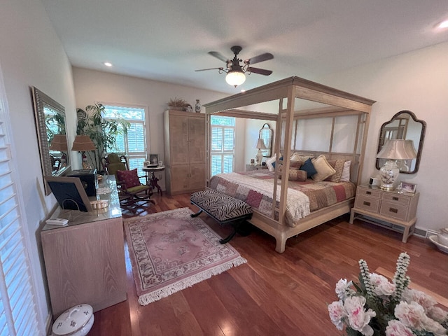 bedroom with dark hardwood / wood-style flooring and ceiling fan