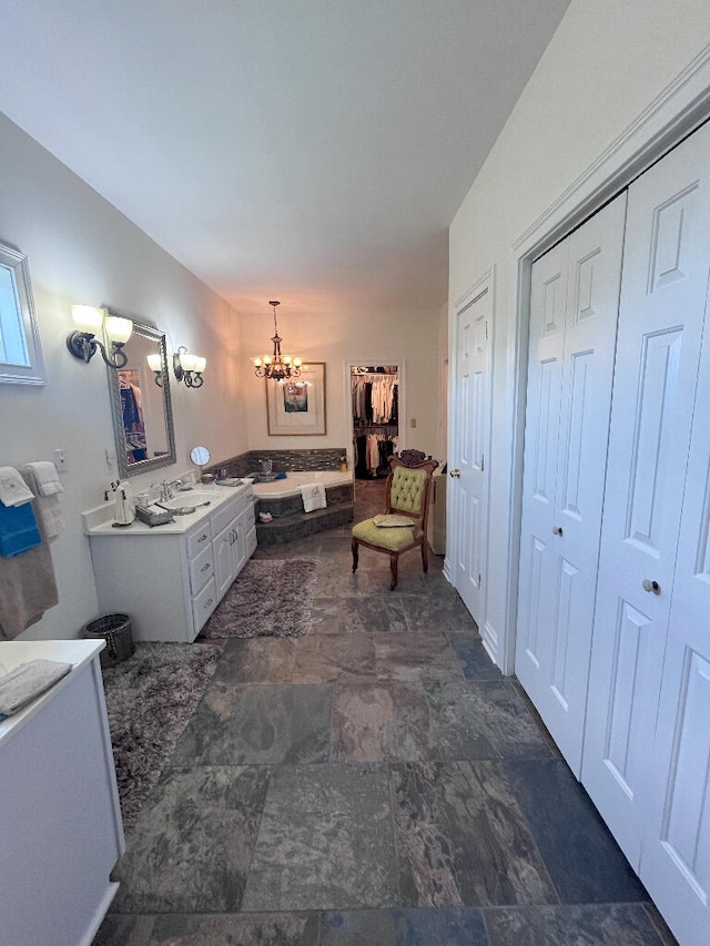 bathroom with tile flooring, an inviting chandelier, and vanity