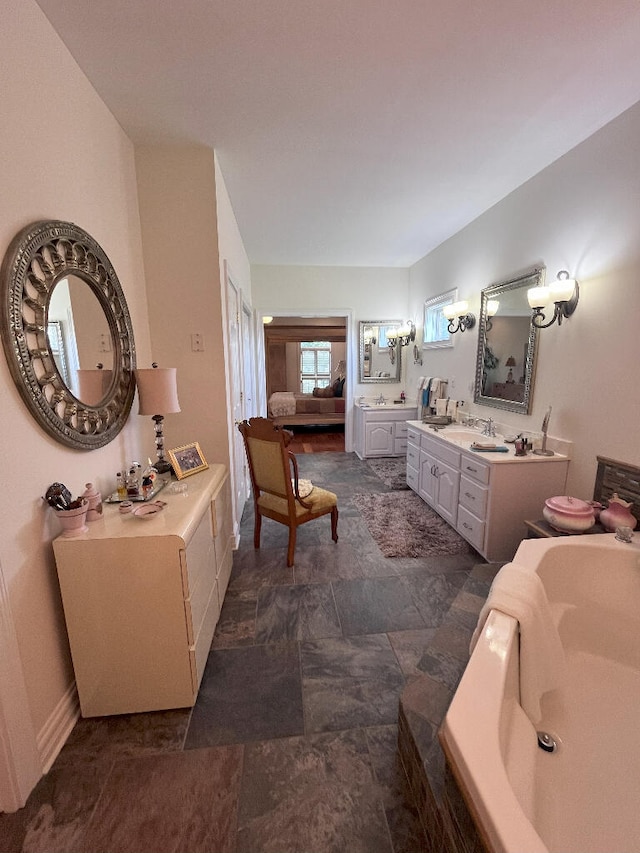 bathroom with a tub, tile flooring, and vanity