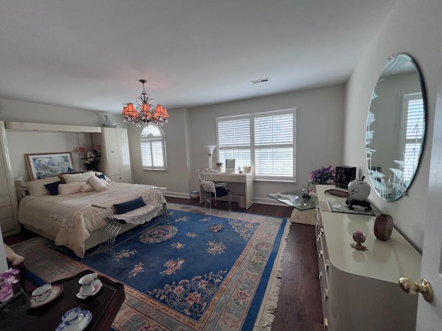 bedroom featuring a notable chandelier and dark hardwood / wood-style flooring