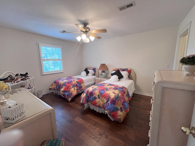 bedroom with dark wood-type flooring and ceiling fan