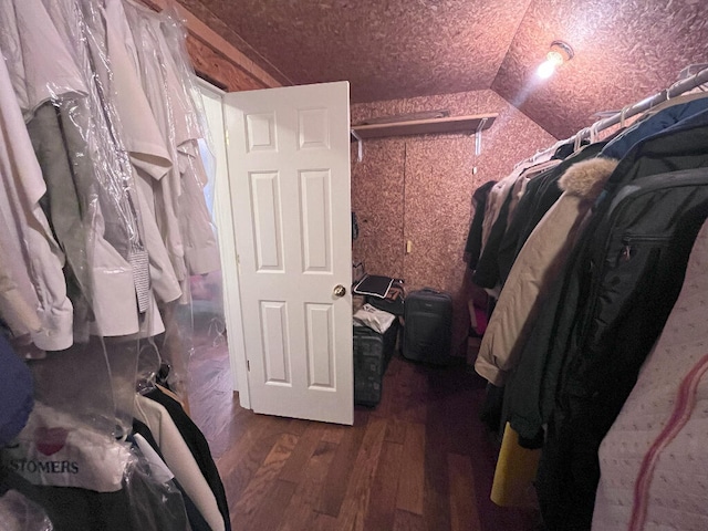 walk in closet featuring lofted ceiling and dark hardwood / wood-style flooring