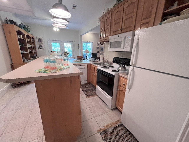 kitchen featuring kitchen peninsula, white appliances, light tile flooring, hanging light fixtures, and sink