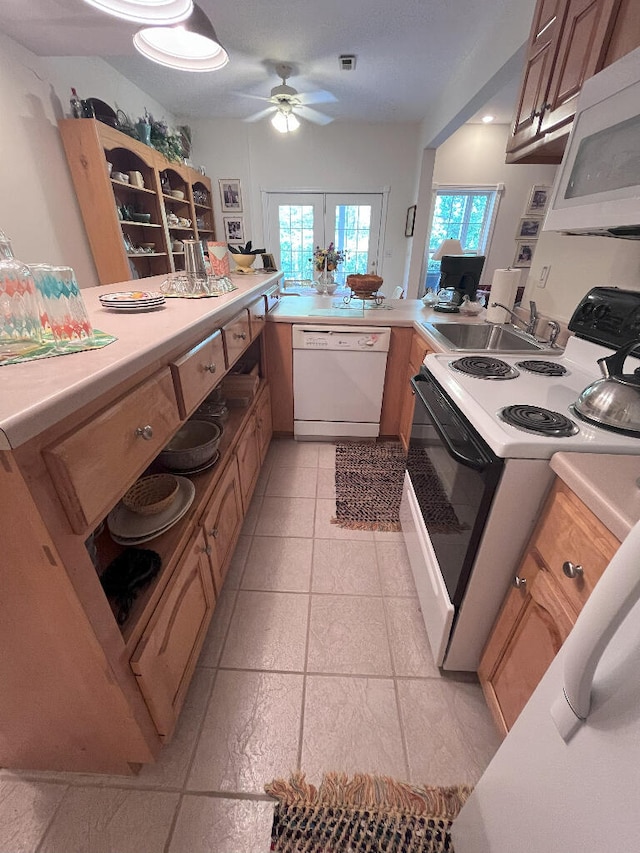 kitchen featuring white appliances, kitchen peninsula, sink, ceiling fan, and light tile floors