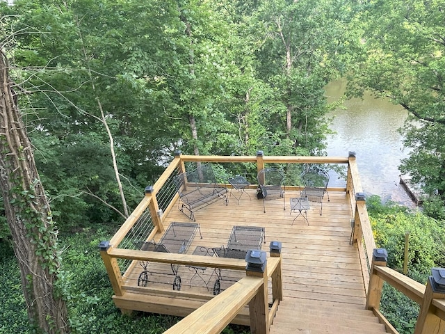 wooden terrace featuring a water view