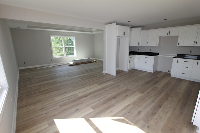 kitchen with white cabinets and light hardwood / wood-style flooring