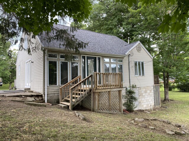 back of house featuring a yard and a wooden deck