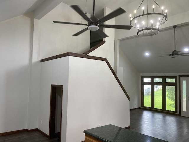 entryway with dark hardwood / wood-style flooring, ceiling fan with notable chandelier, and high vaulted ceiling