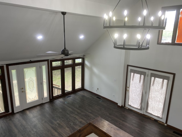 interior space featuring lofted ceiling, dark hardwood / wood-style floors, and a chandelier