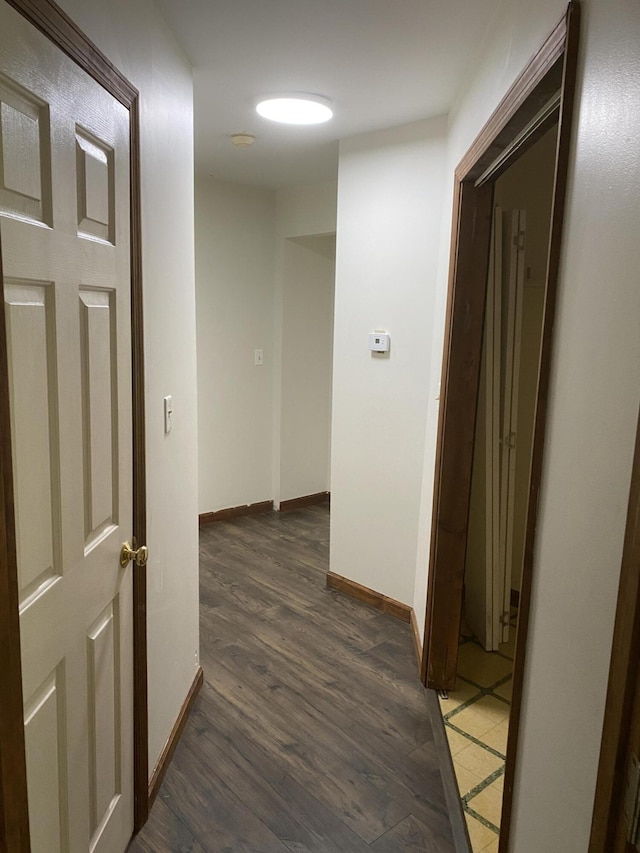 corridor with dark hardwood / wood-style floors