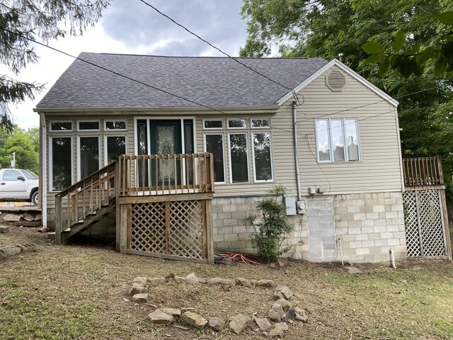 rear view of house with a wooden deck