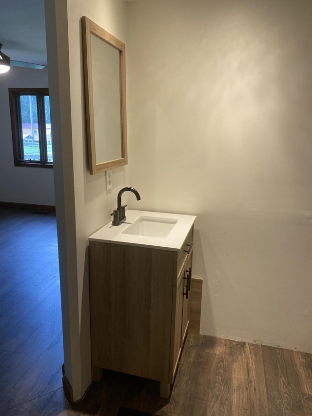 bathroom with vanity, wood-type flooring, and ceiling fan