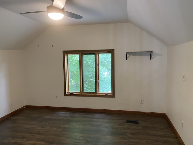 additional living space featuring baseboards, a ceiling fan, lofted ceiling, and dark wood-style flooring