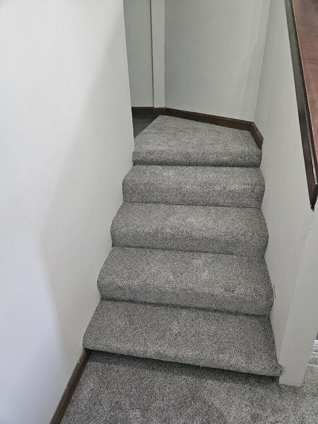 stairway featuring baseboards
