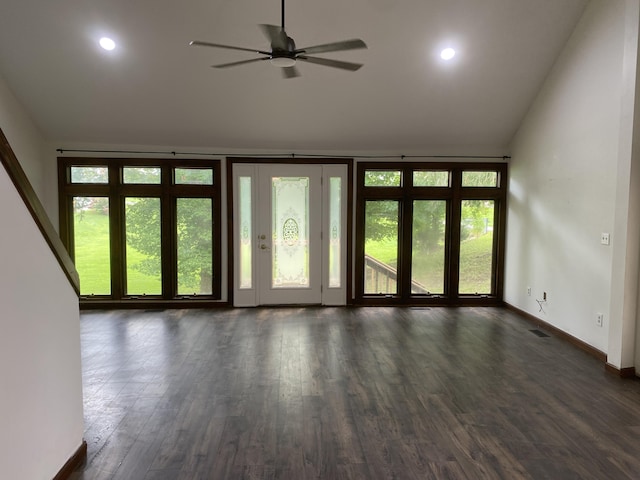 unfurnished living room with dark hardwood / wood-style flooring and ceiling fan