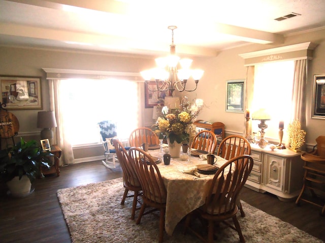 dining area featuring dark hardwood / wood-style floors, crown molding, and an inviting chandelier