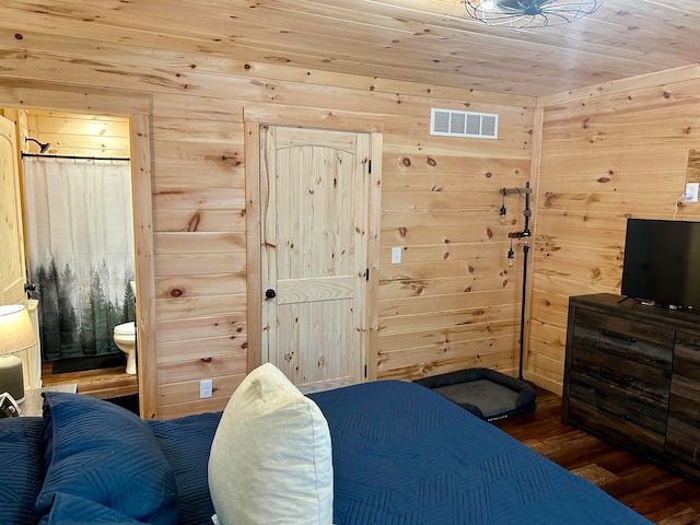 bedroom featuring wooden walls, ensuite bathroom, hardwood / wood-style flooring, and wood ceiling