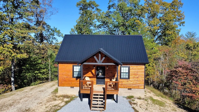 log cabin featuring covered porch