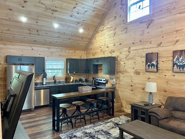 kitchen featuring wood walls, sink, dishwasher, high vaulted ceiling, and dark hardwood / wood-style floors