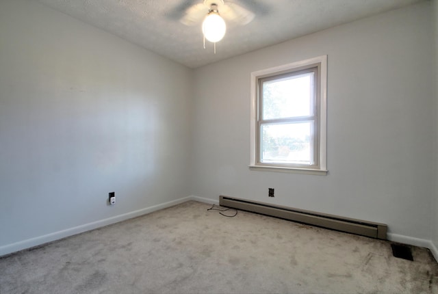 unfurnished room featuring a baseboard heating unit, a textured ceiling, and light carpet