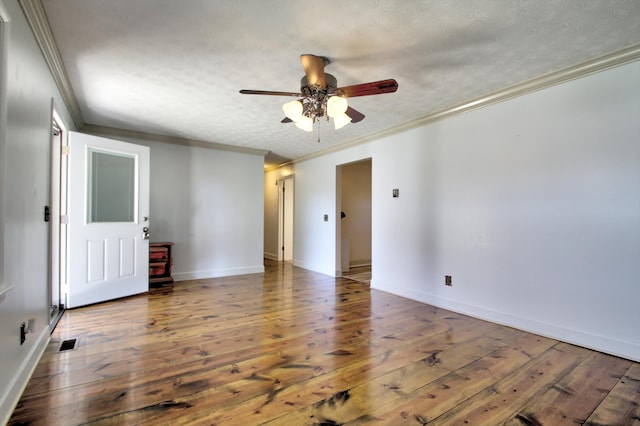 spare room featuring ceiling fan, dark wood-type flooring, a textured ceiling, and crown molding