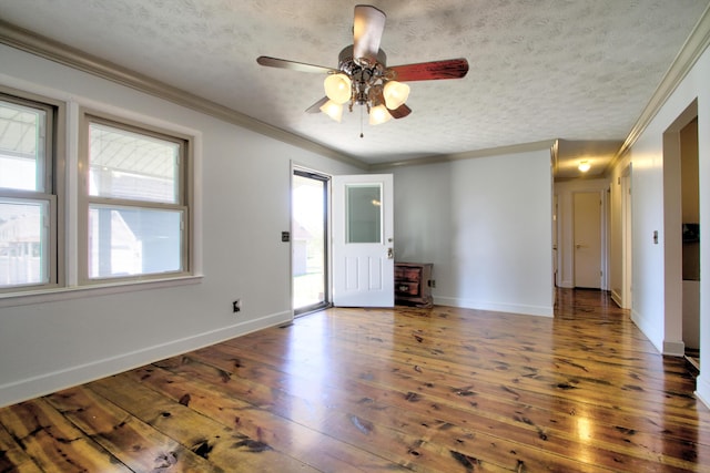 empty room with ceiling fan, a textured ceiling, ornamental molding, and hardwood / wood-style floors