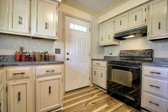 kitchen featuring crown molding, black electric range, cream cabinetry, and light hardwood / wood-style floors