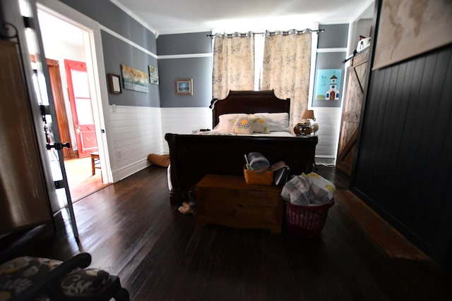 bedroom with ornamental molding and dark hardwood / wood-style floors