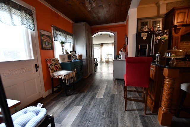 dining area featuring wooden ceiling, crown molding, and dark wood-type flooring