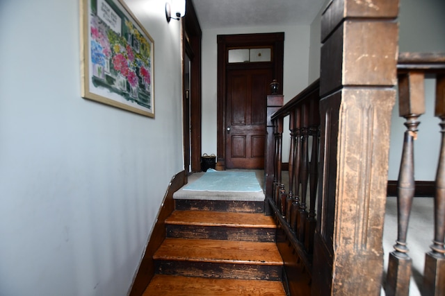 stairs with wood-type flooring