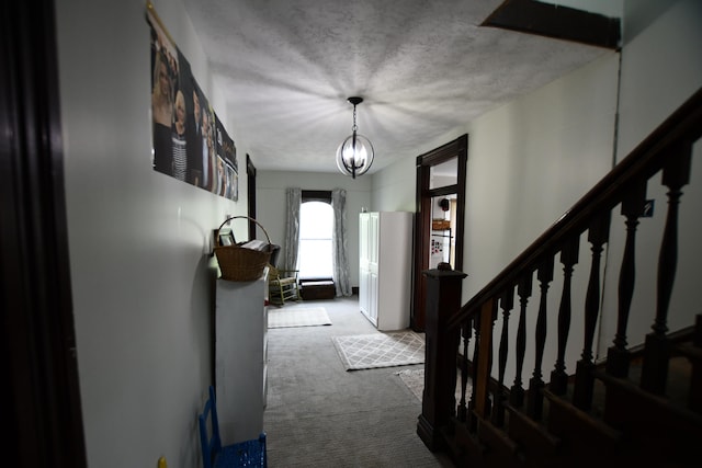 carpeted entryway featuring an inviting chandelier