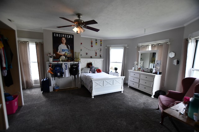 carpeted bedroom with a textured ceiling, ceiling fan, and crown molding