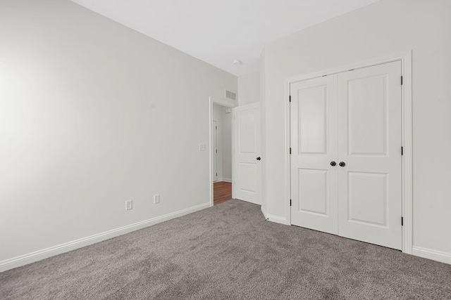 unfurnished bedroom featuring a closet and carpet