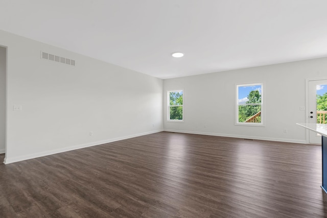 spare room with dark hardwood / wood-style flooring