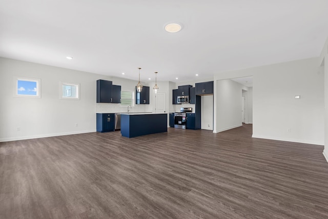 unfurnished living room featuring sink and dark hardwood / wood-style floors