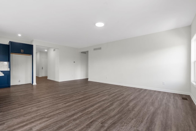 unfurnished living room featuring dark hardwood / wood-style flooring