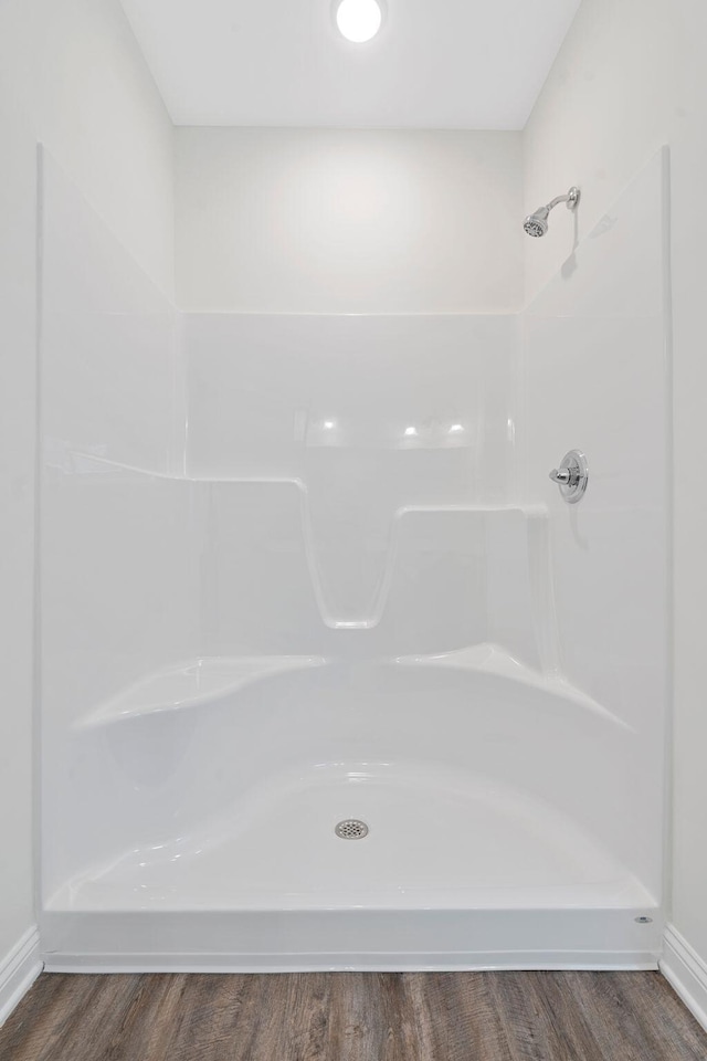 bathroom featuring a shower and wood-type flooring