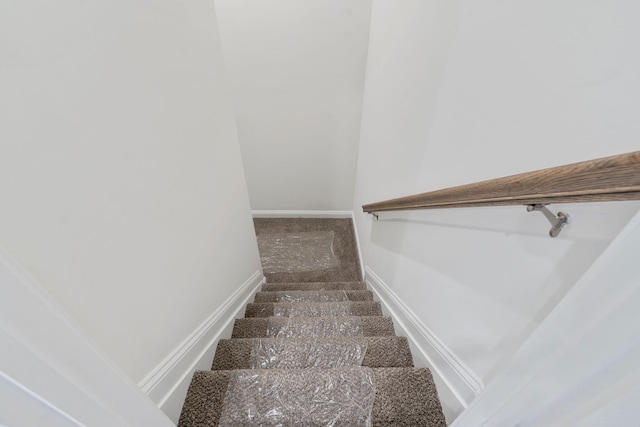 stairs featuring carpet flooring