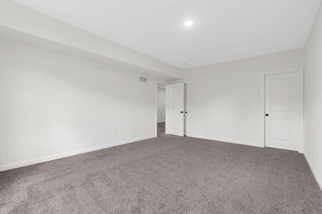 unfurnished room featuring dark carpet