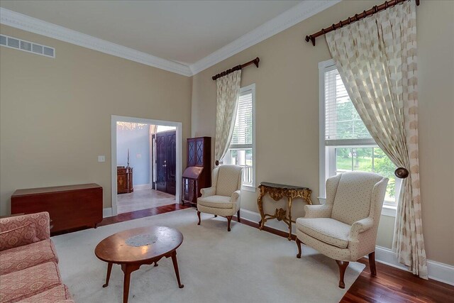 living room with ornamental molding and wood-type flooring