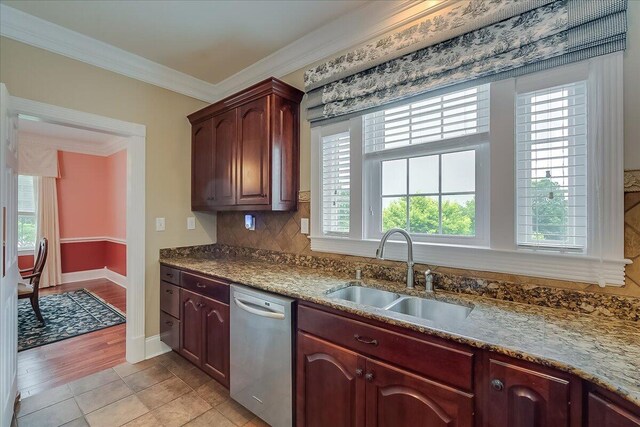 kitchen featuring tasteful backsplash, dishwasher, light tile flooring, sink, and ornamental molding