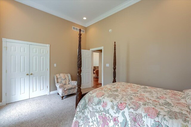 bedroom featuring a high ceiling, carpet flooring, a closet, and crown molding