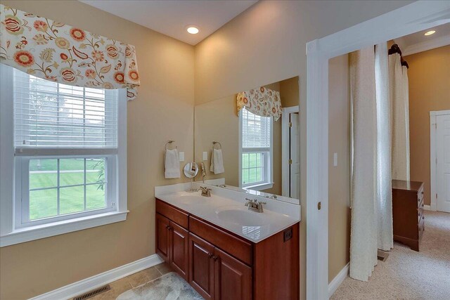 bathroom with tile flooring and vanity