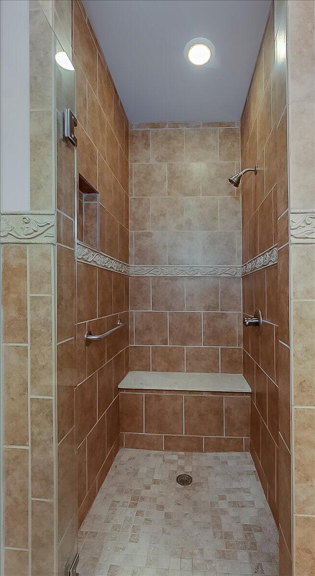 bathroom with a tile shower