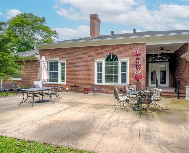 rear view of property featuring ceiling fan, french doors, and a patio