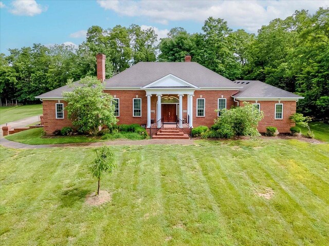 neoclassical / greek revival house with a front lawn