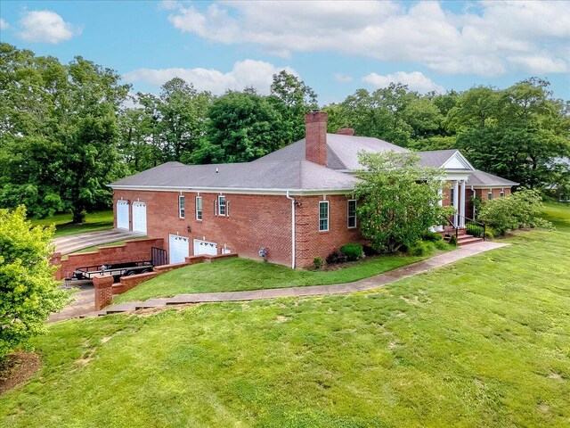 back of property featuring a lawn